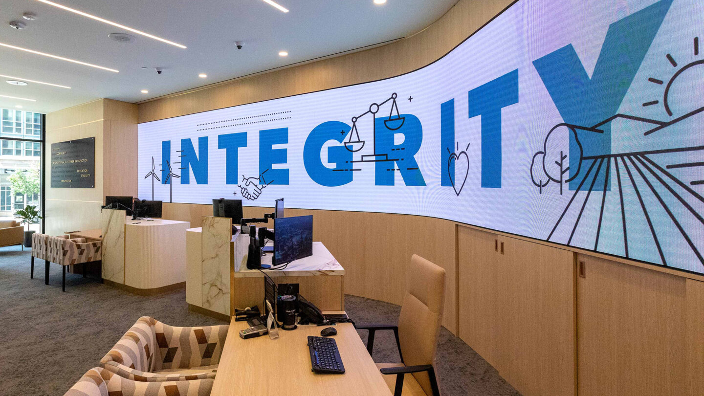 Digital signage display with the word "Integrity" on-screen